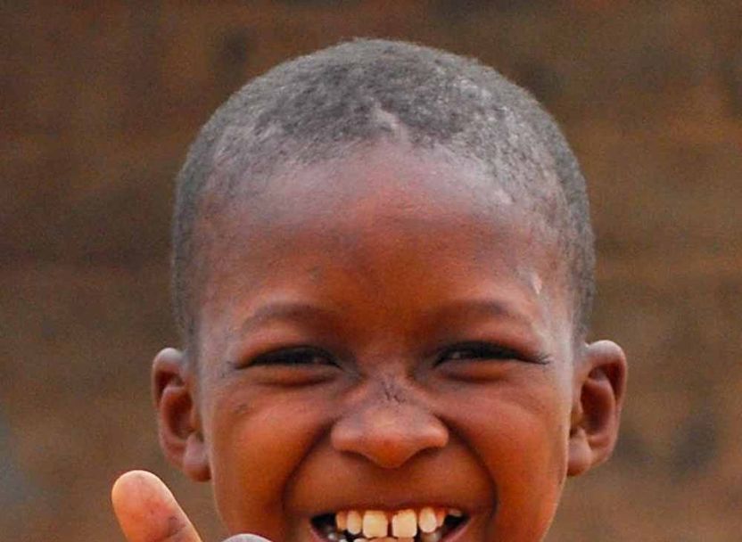 A smiling boy giving a thumbs up