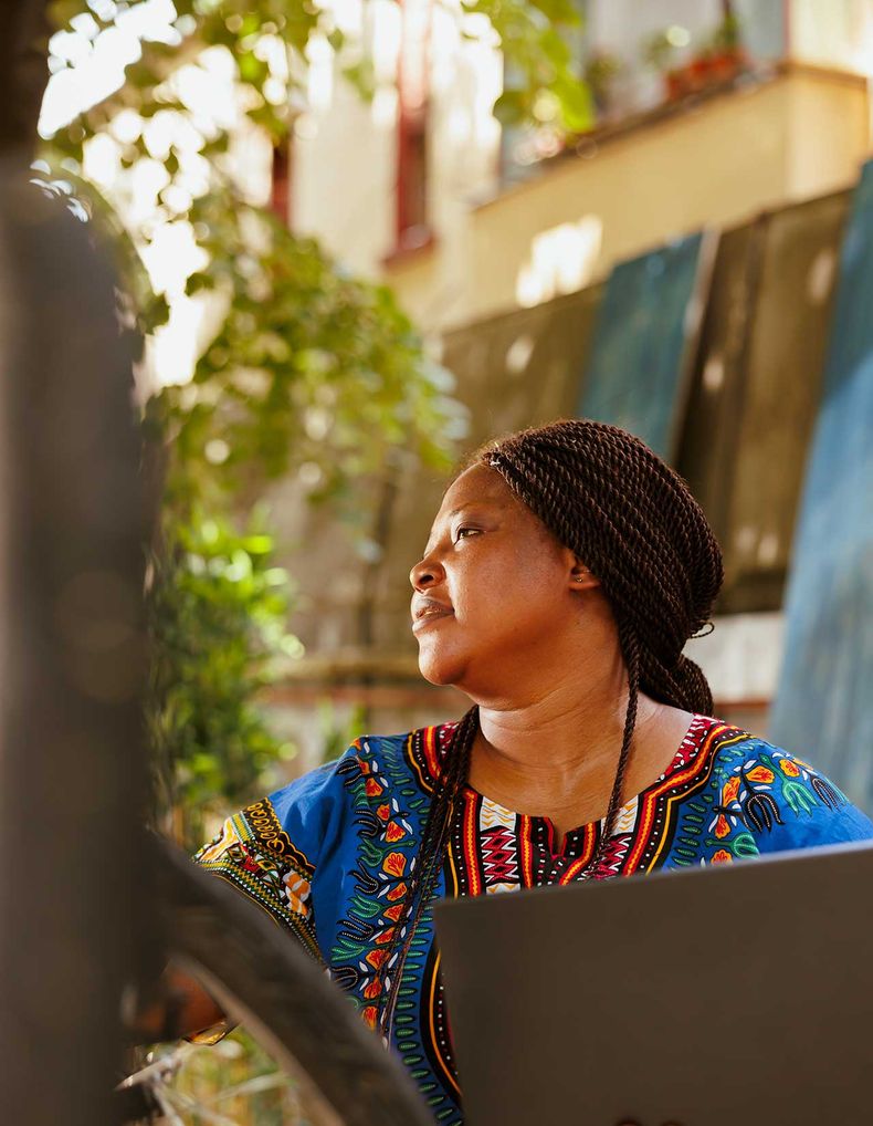A woman holding a laptop outdoors