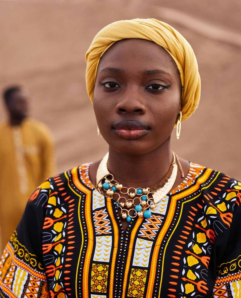 A young woman in a yellow headwrap