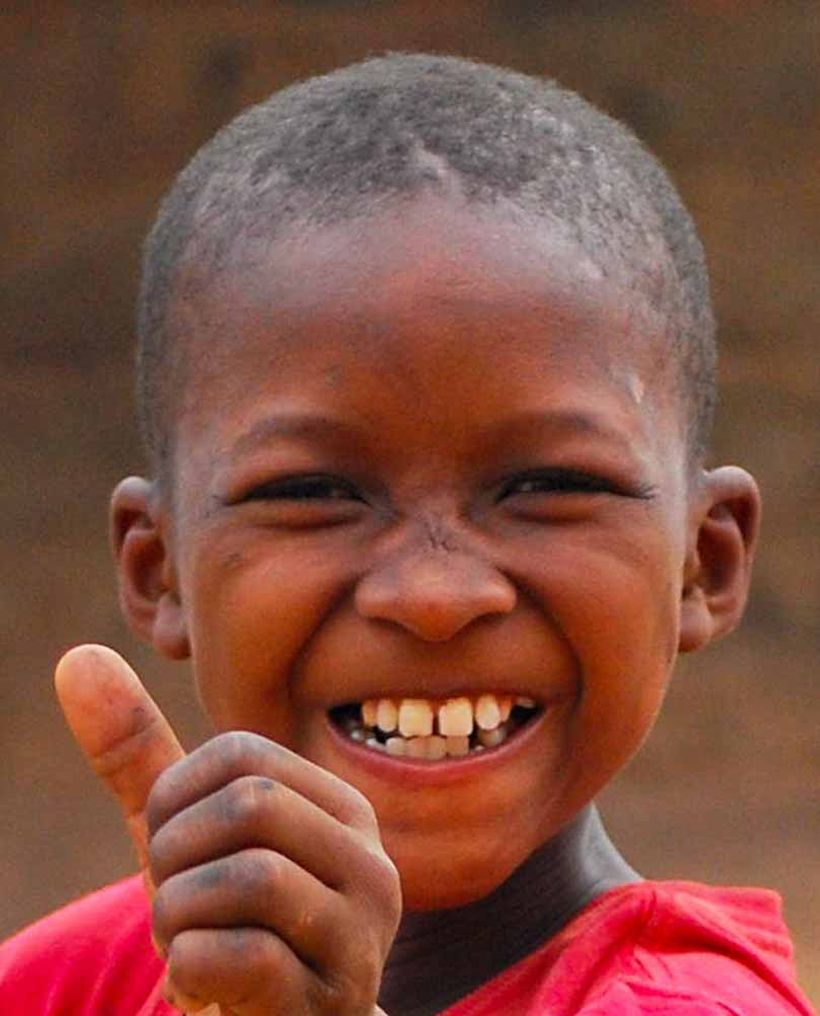 A boy giving a thumbs up