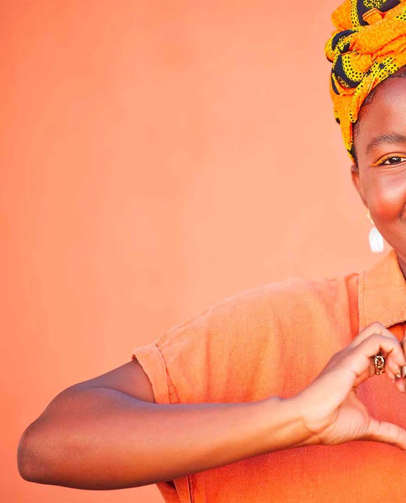 A woman making a heart with her hands