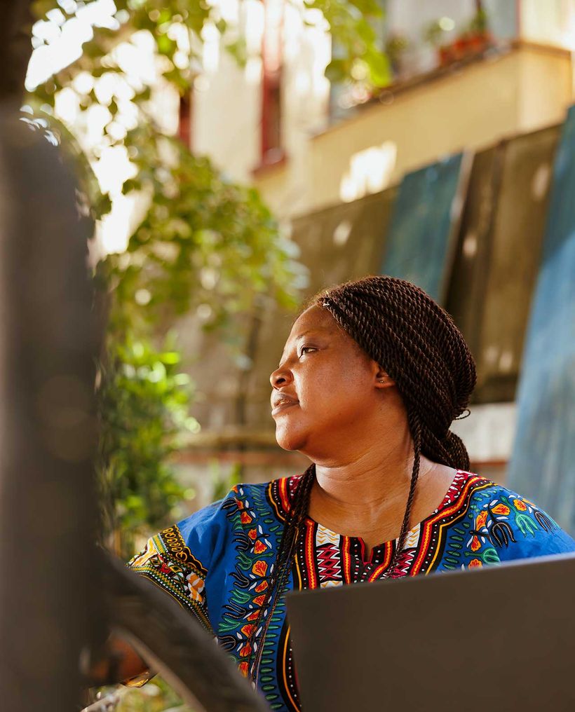 A woman holding a laptop outdoors